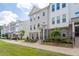 Desirable townhomes featuring brick accents, landscaped yards, and inviting entrances at 361 Watson Ave, Woodstock, GA 30189