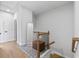 Upstairs hallway with wood floors and staircase in neutral tones at 361 Watson Ave, Woodstock, GA 30189