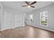 Hardwood floors and lots of natural light fill this living room with ceiling fan at 361 Watson Ave, Woodstock, GA 30189