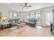 Cozy living room with large windows, hardwood floors, and comfortable seating area at 361 Watson Ave, Woodstock, GA 30189