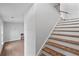 Staircase with wood treads and carpet runners, leading to an open living space at 361 Watson Ave, Woodstock, GA 30189