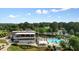 Stunning aerial view of a community clubhouse, golf course, and sparkling pool area at 11940 Mountain Laurel Dr, Roswell, GA 30075