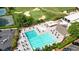 Beautiful aerial view of a pool with lounge chairs, umbrellas and tennis courts surrounded by trees at 11940 Mountain Laurel Dr, Roswell, GA 30075