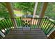 Private balcony with decorative iron railing, offering a serene view of the surrounding landscape at 11940 Mountain Laurel Dr, Roswell, GA 30075