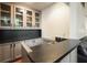 Stylish wet bar with sleek countertops and glass-front cabinets at 11940 Mountain Laurel Dr, Roswell, GA 30075