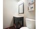 Bathroom featuring a dark vanity with a marble countertop and a toilet with abstract artwork at 11940 Mountain Laurel Dr, Roswell, GA 30075