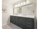 Bathroom featuring a double sink vanity with dark cabinets and a light countertop at 11940 Mountain Laurel Dr, Roswell, GA 30075