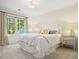 Bedroom featuring neutral tones and natural light from large windows overlooking a leafy yard at 11940 Mountain Laurel Dr, Roswell, GA 30075