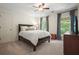 Cozy bedroom featuring neutral walls, carpeted floor, and stylish dark wood furnishings at 11940 Mountain Laurel Dr, Roswell, GA 30075