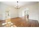 Dining room featuring hardwood floors and classic wainscoting at 11940 Mountain Laurel Dr, Roswell, GA 30075