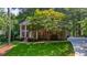 Well-maintained two-story brick home with lush landscaping and a charming front yard at 11940 Mountain Laurel Dr, Roswell, GA 30075