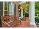 Charming front porch featuring a bench and patterned tile floor at 11940 Mountain Laurel Dr, Roswell, GA 30075