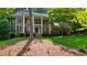 Classic brick home with columns, a balcony, and a beautifully landscaped front yard at 11940 Mountain Laurel Dr, Roswell, GA 30075