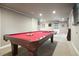 Spacious game room with a classic billiard table, recessed lighting, and neutral carpeting at 11940 Mountain Laurel Dr, Roswell, GA 30075
