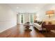 Bright living room featuring hardwood floors, neutral décor, and natural light at 11940 Mountain Laurel Dr, Roswell, GA 30075