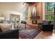 Inviting living room with a brick fireplace, vaulted ceilings, and natural light at 11940 Mountain Laurel Dr, Roswell, GA 30075