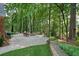 Spacious stone patio with a cozy fire pit and lush greenery at 11940 Mountain Laurel Dr, Roswell, GA 30075