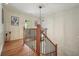 Second floor landing with wooden railings and hardwood floors at 11940 Mountain Laurel Dr, Roswell, GA 30075