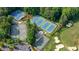 Aerial view showcasing multiple well-maintained tennis courts surrounded by lush greenery at 11940 Mountain Laurel Dr, Roswell, GA 30075