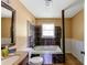 Bathroom featuring a tiled shower, pedestal sink and natural light at 3220 Memorial Dr, Decatur, GA 30032