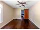 A bedroom featuring a dark wooden barn door, ceiling fan, light walls, and dark wood flooring at 3220 Memorial Dr, Decatur, GA 30032