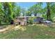 Charming single-story home featuring a wooden deck and lush greenery surrounding the property at 3220 Memorial Dr, Decatur, GA 30032