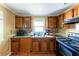 Functional kitchen equipped with a double sink, granite countertops, and dark wood cabinetry at 3220 Memorial Dr, Decatur, GA 30032
