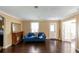 Living room with hardwood floors, a vintage fireplace and natural light from multiple windows at 3220 Memorial Dr, Decatur, GA 30032