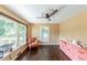 Bright living room with hardwood floors, a ceiling fan and large windows overlooking the backyard at 3220 Memorial Dr, Decatur, GA 30032