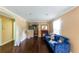 Cozy living room featuring dark hardwood floors, crown molding, and a bright window at 3220 Memorial Dr, Decatur, GA 30032