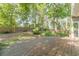 Fenced backyard with a spacious wooden deck and mature trees, creating a private outdoor oasis at 3830 Gallant Fox Ct, Duluth, GA 30096
