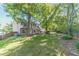 Expansive backyard with mature trees, lush greenery, and a wooden deck, providing a serene outdoor retreat at 3830 Gallant Fox Ct, Duluth, GA 30096