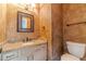 Cozy powder room featuring textured walls and granite countertop at 3830 Gallant Fox Ct, Duluth, GA 30096