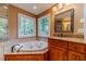 Bathroom featuring jacuzzi tub and sink with cabinet at 3830 Gallant Fox Ct, Duluth, GA 30096