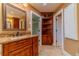 Bathroom with tiled floor, wood cabinets and granite counters at 3830 Gallant Fox Ct, Duluth, GA 30096