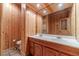 Bathroom with double sinks, wood paneled walls and a large mirror at 3830 Gallant Fox Ct, Duluth, GA 30096