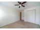 Spacious bedroom with neutral carpet, ceiling fan, and closet at 3830 Gallant Fox Ct, Duluth, GA 30096