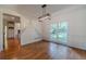 Bright dining room with hardwood floors, modern light fixture, and a large window overlooking the backyard at 3830 Gallant Fox Ct, Duluth, GA 30096