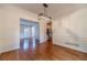 Bright dining room showcasing hardwood floors, stylish light fixture, and a seamless flow to other living spaces at 3830 Gallant Fox Ct, Duluth, GA 30096