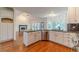 Open kitchen featuring stainless steel appliances, granite countertops, white cabinets and view to the living room at 3830 Gallant Fox Ct, Duluth, GA 30096