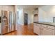 Open-concept kitchen featuring stainless steel refrigerator, granite counters, and seamless flow to other spaces at 3830 Gallant Fox Ct, Duluth, GA 30096