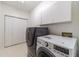 Modern laundry room with washer, dryer, and storage cabinets at 3830 Gallant Fox Ct, Duluth, GA 30096