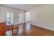 Bright living area with hardwood floors, large windows, and a classic piano, creating an inviting space at 3830 Gallant Fox Ct, Duluth, GA 30096