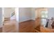 Living room showcases beautiful hardwood floors and is open to the dining and staircase at 3830 Gallant Fox Ct, Duluth, GA 30096