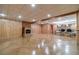 Spacious basement living area with fireplace, bar, and wood-paneled walls at 3830 Gallant Fox Ct, Duluth, GA 30096