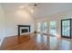 Spacious living room featuring a fireplace, hardwood floors, and natural light at 3830 Gallant Fox Ct, Duluth, GA 30096