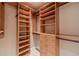 Custom walk-in closet with built-in shelving, drawers, and ample hanging space at 3830 Gallant Fox Ct, Duluth, GA 30096