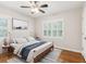 This staged bedroom offers windows with hardwood floors; perfect for new owners at 6878 Brandon Mill Rd, Sandy Springs, GA 30328