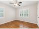 Bright bedroom with windows and hardwood floors; ready for a new design at 6878 Brandon Mill Rd, Sandy Springs, GA 30328