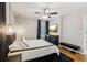 This bedroom offers a ceiling fan, stylish decor, and a dark rug for a cozy and modern aesthetic at 6878 Brandon Mill Rd, Sandy Springs, GA 30328